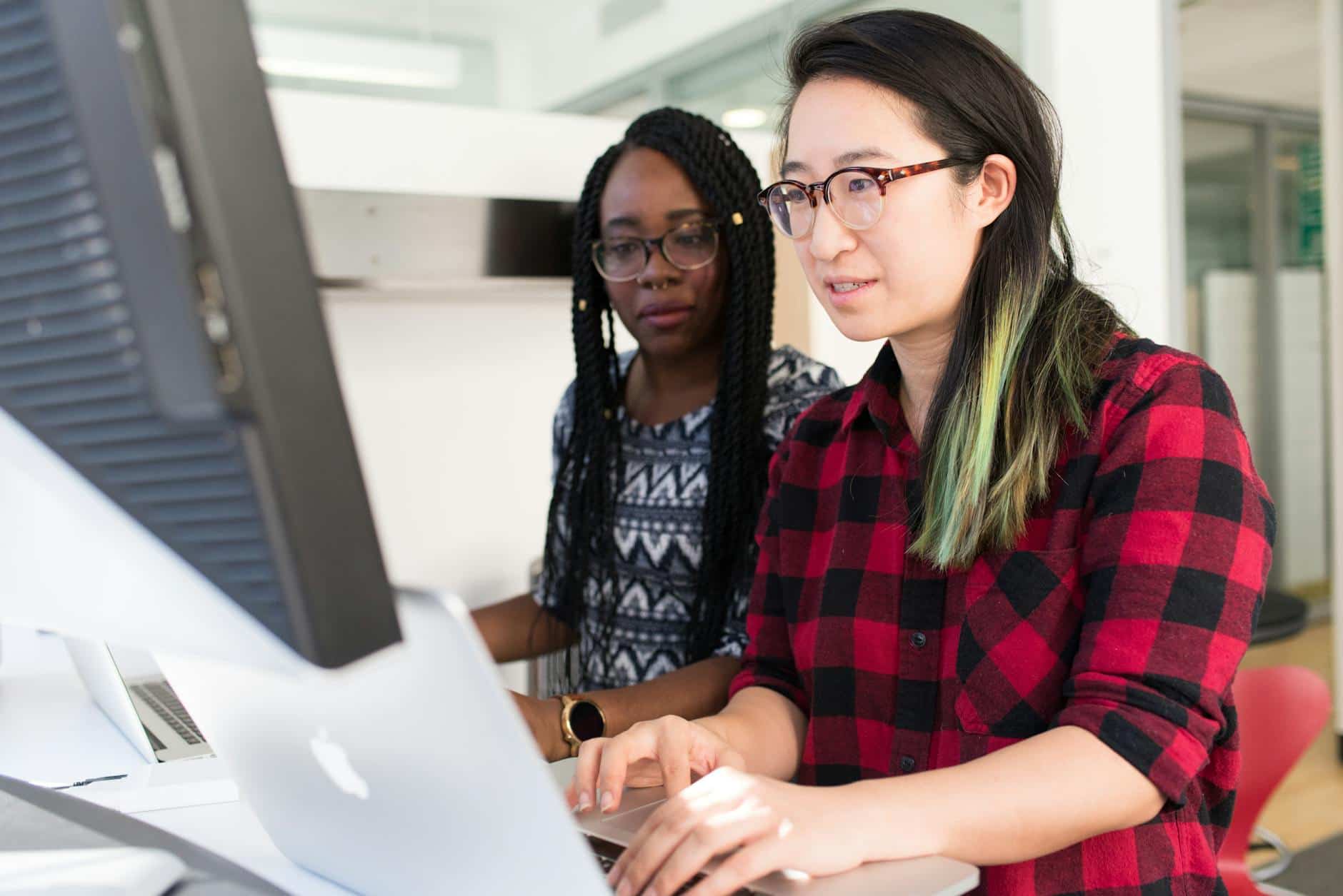 business reputation 
woman wearing red and black checkered blouse using macbook